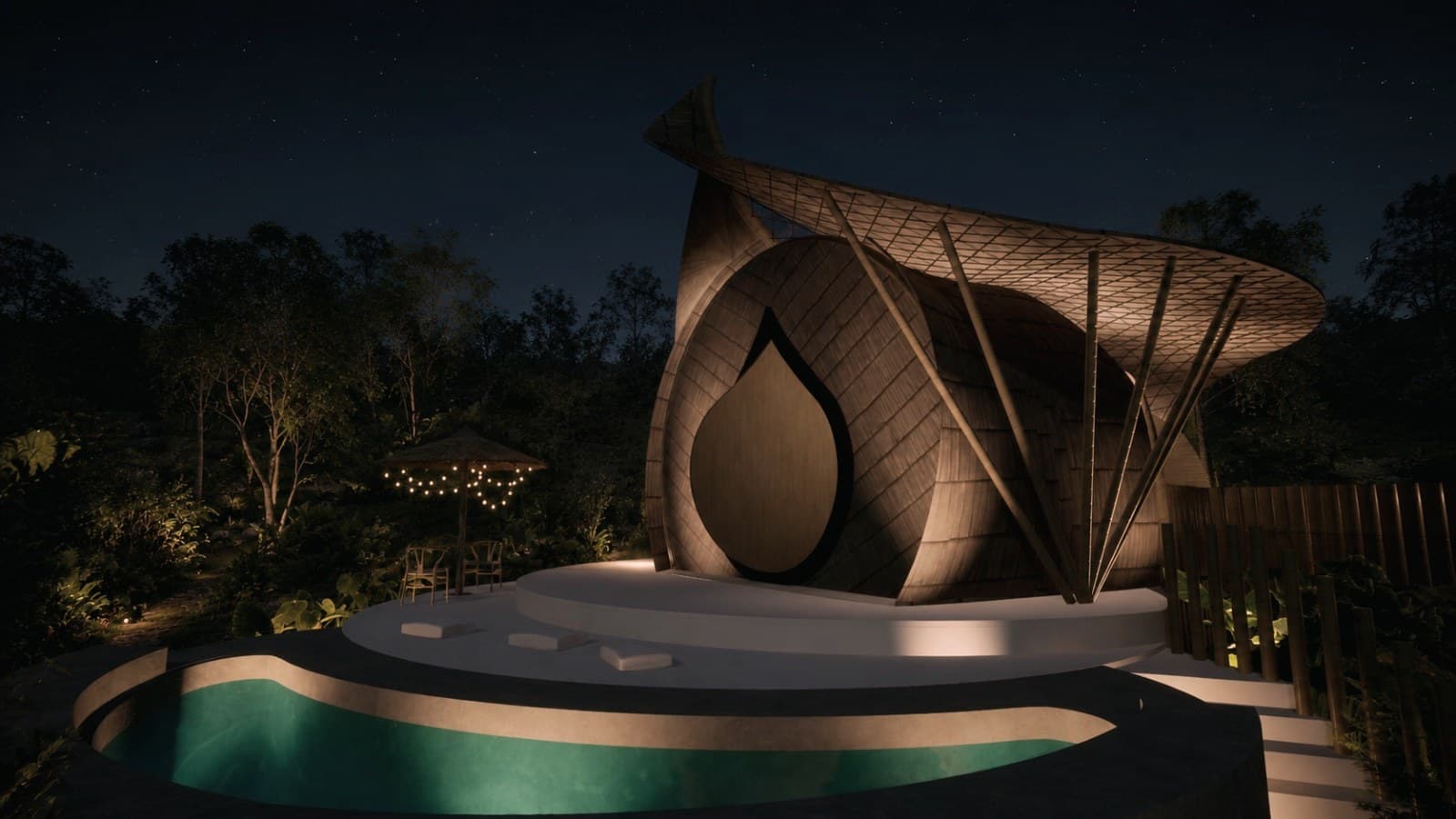 Villa Aruma at night, the curved bamboo villa glowing beside the garden