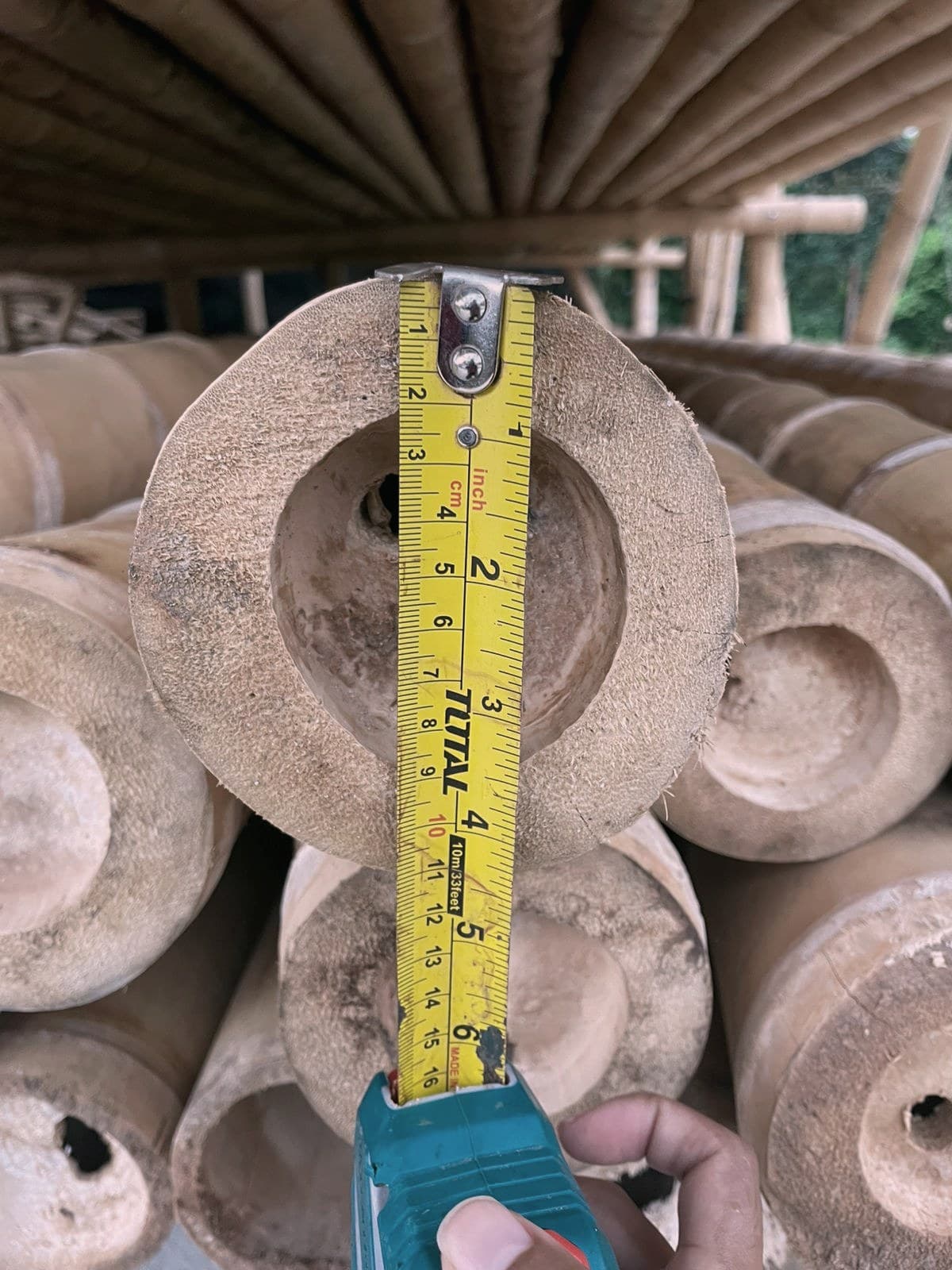 Raw guadua bamboo poles before treatment at the DUAGUA factory