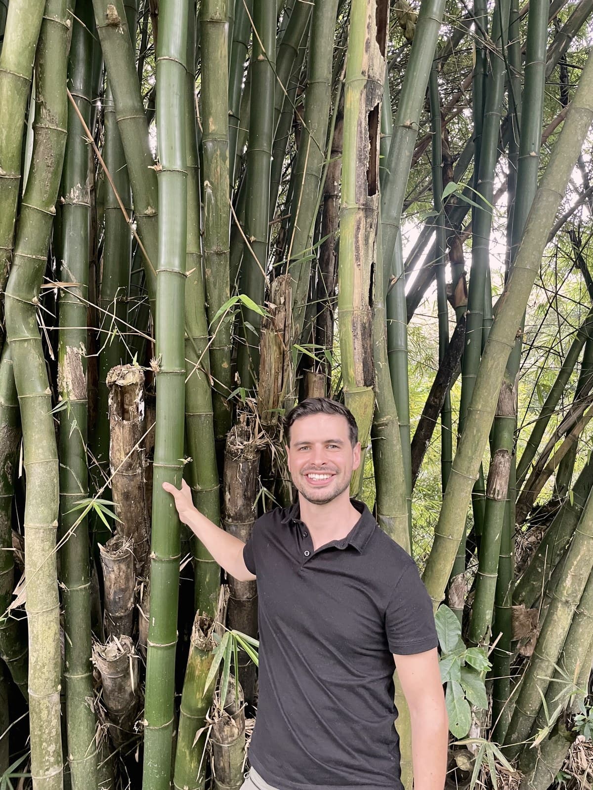 Justin Fransen, co-founder of DUAGUA, beside a stand of living guadua