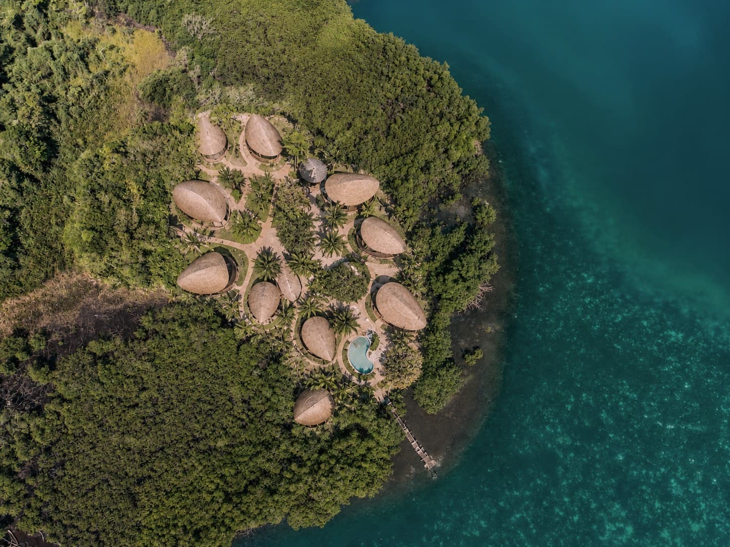 Aerial concept of the Sibö resort, seed-shaped bamboo villas on a peninsula